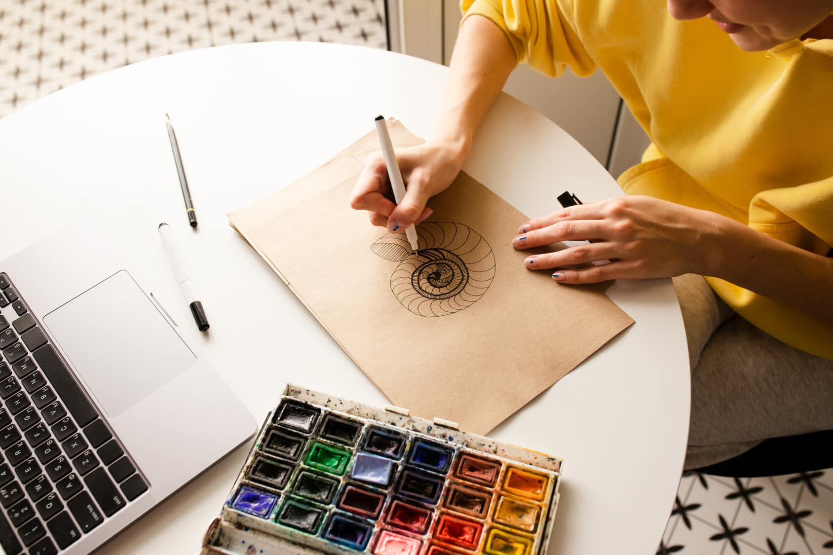 Woman drawing a sketch using a capillary pen Woman drawing a sketch using a capillary pen